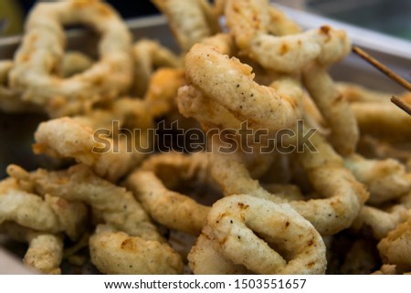 Delicious deep fried rings of squid close up.