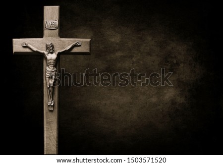 Dark sepia black and grey toned crucifix on large antiqued background - concept that Jesus is Savior for all history always