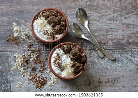 Keto diet. Greek yogurt with flax seeds, sesame seeds and chocolate crunches. Keto friendly breakfast or dessert.