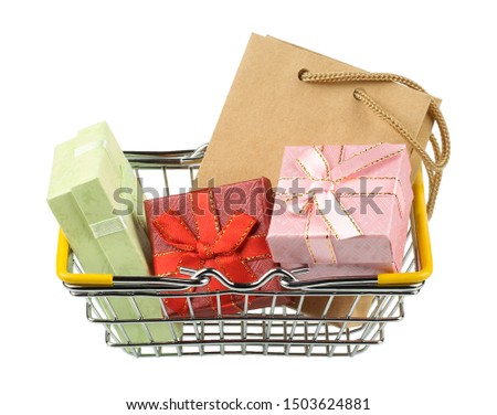 The shopping basket with different colored boxes and gifts. Isolated picture.