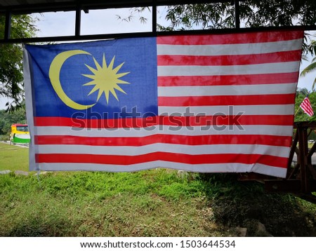 View of Malaysia flag thst called 'Jalur Gemilang' hanging up with nature background 