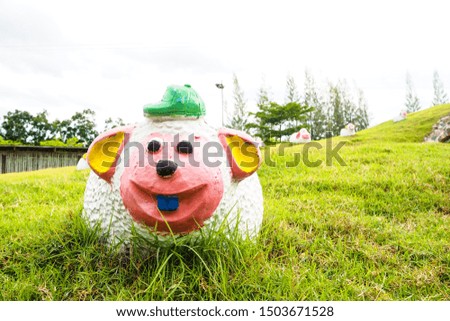 A sheep doll in a meadow on a hill