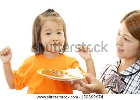 Child eating meal with mother