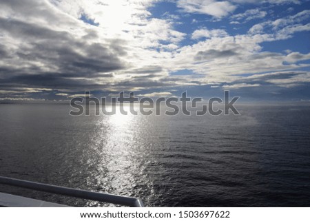 A picture of the sea, some clouds, and the sun.
BC Canada
