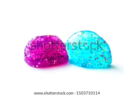 Modern toy for kids called slime. Transparent blue and purple mucus isolated on a white background.	