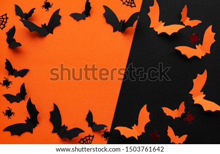 holidays  concept - halloween paper decorations  with blank copy space over  orange and black background