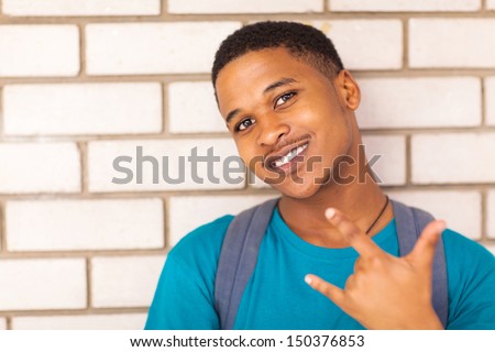 happy african American college boy giving hand sign