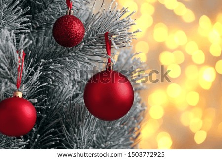 Decorated Christmas tree against blurred lights on background. Bokeh effect