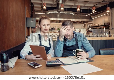 Young entrepreneurs overwhelmed by finance problems - Nervous manager checking restaurant finance - Failure in small-business concept Royalty-Free Stock Photo #1503786101