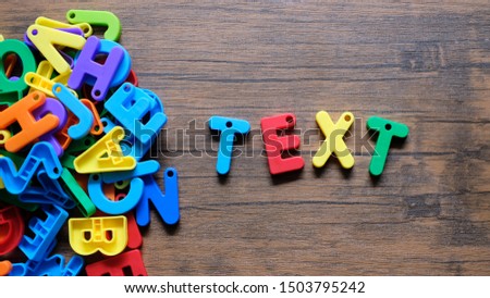 'Text' Colorful word on the wooden background