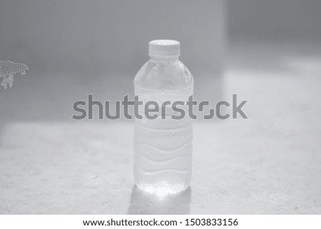 Plastic Bottled Drinking on white concrete background during daytime, pure and clean water, refreshing, thirsty, carbonated.  