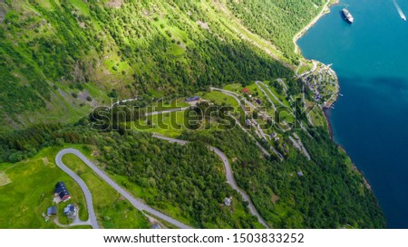 Splendid summer sunset of Sunnylvsfjorden fjord canyon, Geiranger village location, western Norway. Aerial evening view of famous Seven Sisters waterfalls. Beauty of nature concept background.