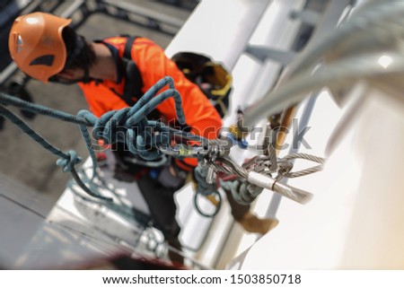 Rope access worker rigged anchor point with locking carabiners connecting with Wire Rope Slings Standard 6x36 IWRC B with thimble or soft eyes for best safety protection practice solution, abseiling 