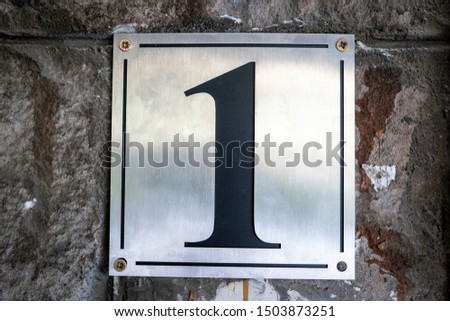 Street number sign on the wall