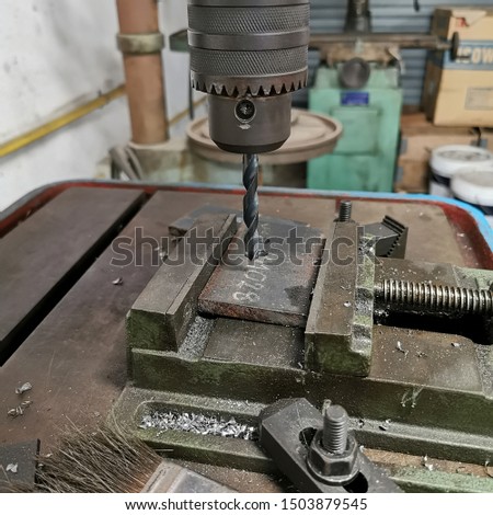 the​ drill head​ of​ drilling  machine in old factory industry