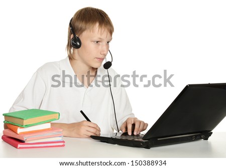 Teenage boy sitting at a desk with books