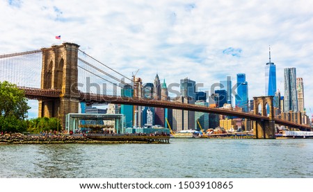 Brooklyn Bridge with skyscrapers background. New York City, USA. Brooklyn Bridge is linking Lower Manhattan to Brooklyn.
