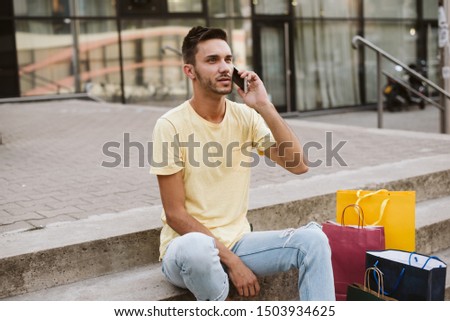 Gay sitting on the steps after shopping. LGBT population