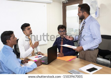 Dissatisfied businessman arguing with colleagues at office boardroom meeting Royalty-Free Stock Photo #1503967001