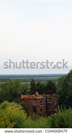 Rural scene of abandoned building at hill by sky line