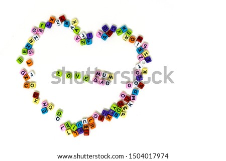 A close up alphabet heart shape shot of ABC blocks with word ( love mam and love dad ) on isolated white background 