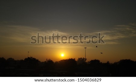A perfect landscape sunrise picture showing cloudy sky and red, yellowish sunlight. 