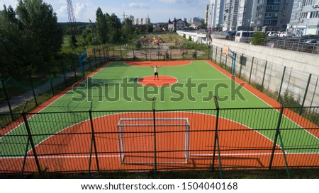 Soccer field among tall houses in the city