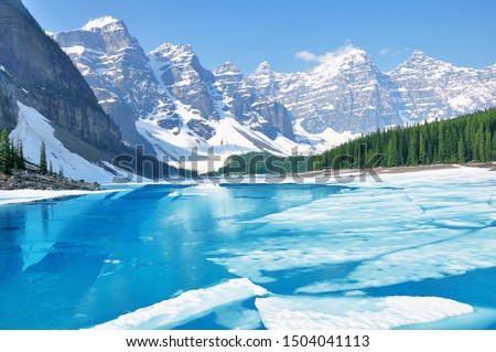 Moraine lake under the ice at morning spring time. Banff National park. Canada. Royalty-Free Stock Photo #1504041113