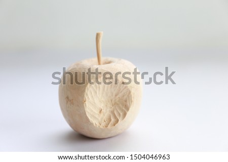 Apple shaped wood carving with bite marks