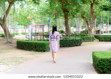 Woman walking in the garden, Thailand