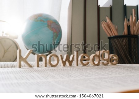 knowledge word on a book and school stationary background ,Education and knowledge concept  