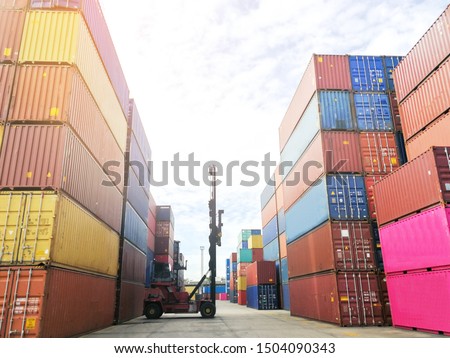 Crane lifting up empty container in yard Royalty-Free Stock Photo #1504090343