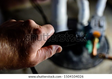 Power outage with flash light shining on sump pump Royalty-Free Stock Photo #1504104026