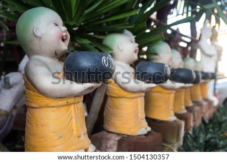 novice buddhist monk sculptures in temple.