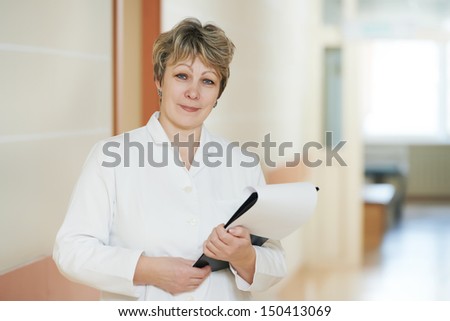 Adult female doctor in hospital clinic hall