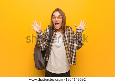 Young student woman celebrating a victory or success