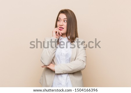 Young business woman relaxed thinking about something looking at a copy space.