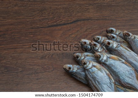 some dried fish on a dark wooden background/