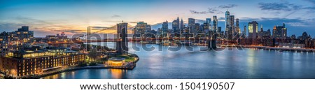 New York City skyline panorama at sunset overlooking the Brooklyn Bridge and East river