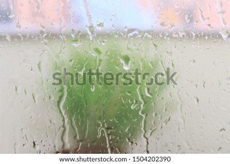Glass wall inside home when raining.  photo