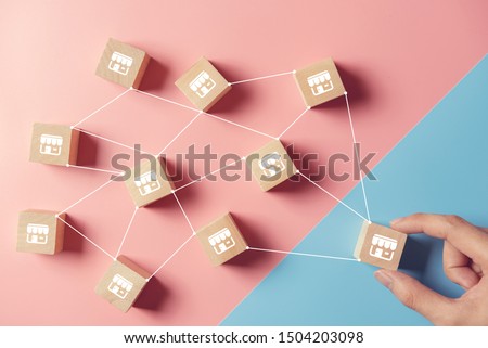 Woman hand choose wood blog with franchise marketing system in global network connection. Franchise business concept. Royalty-Free Stock Photo #1504203098