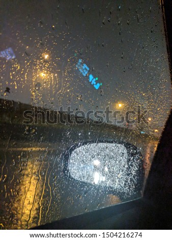 Rainy wet car window view from the passenger side door