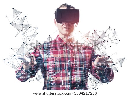 Young man wearing VR goggles and gaming in interactive game. Guy in checkered shirt manipulating virtual network system. Digital entertainment in cyberspace. Future technologies and new experience