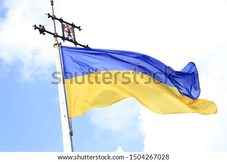 Ukraine flag waves on sky