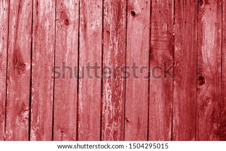Weathered wooden fence in red color. Abstract background and texture for design.