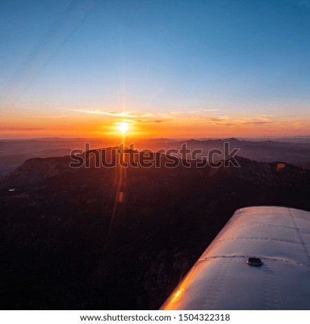 Flying above clouds city skyline mountains sunset cloud surfing