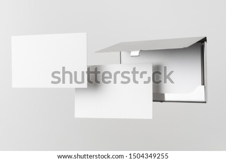 Design concept - top view of horizontal business card with stainless steel case float in the air and isolated on white background for mockup, it's real photo, not 3D render