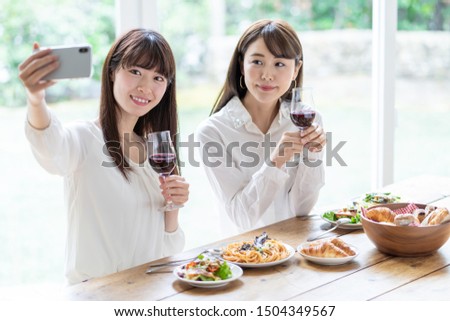 attractive asian women enjoying lunch in living room