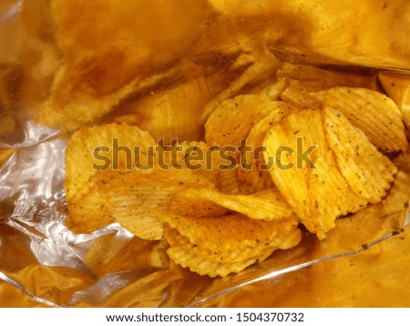 Potato chips in the bag Royalty-Free Stock Photo #1504370732