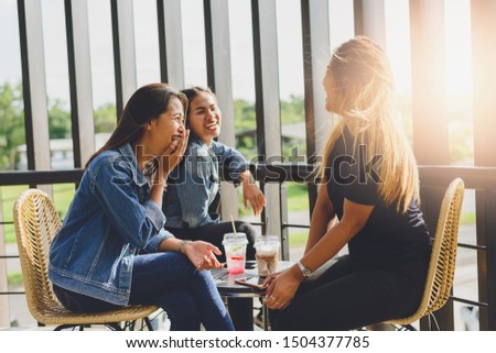 Portrait of cheerful young friends in Cafe Multiracial happy young people laughing enjoying meal having fun sitting together.pleasant conversation during coffee break.